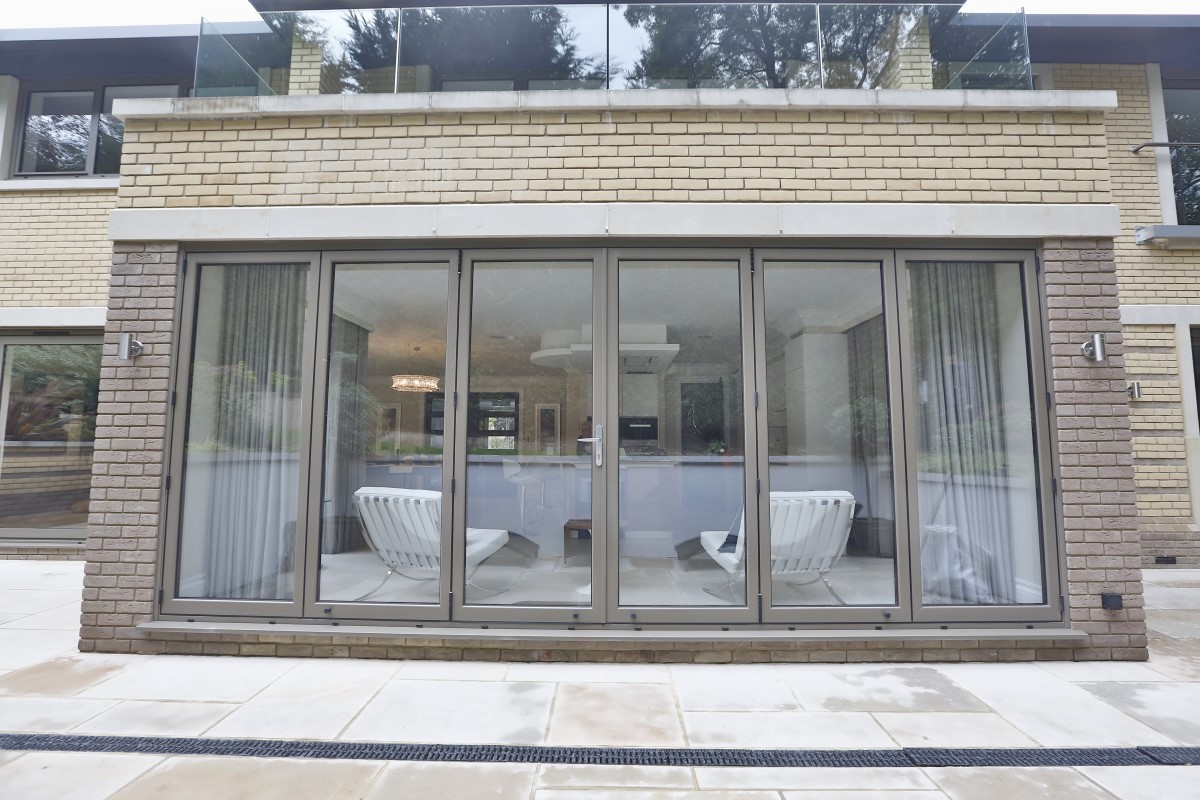 The front view of a set of grey bi fold doors.